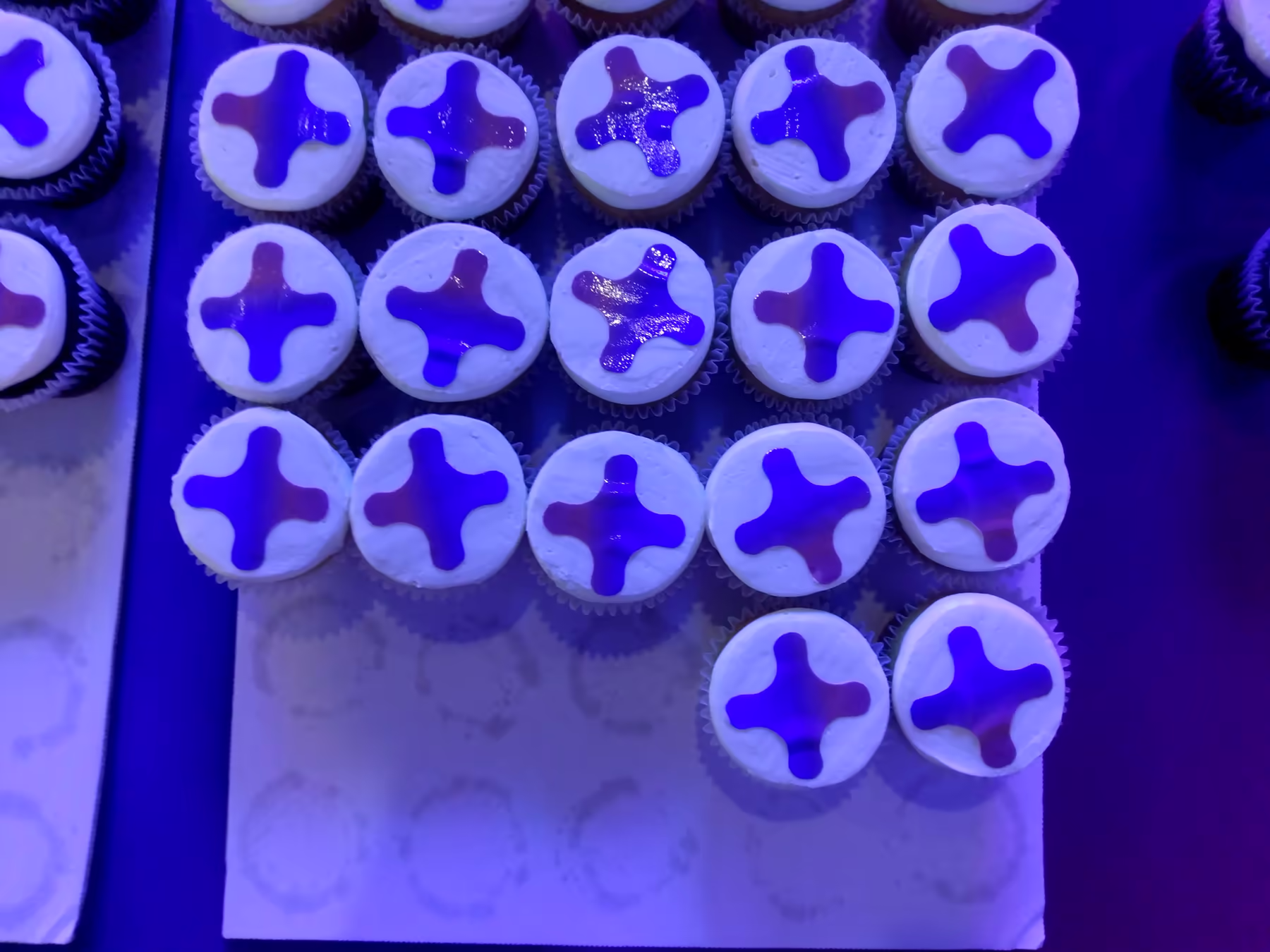 Cupcakes with the CCAM logo on top of the frosting